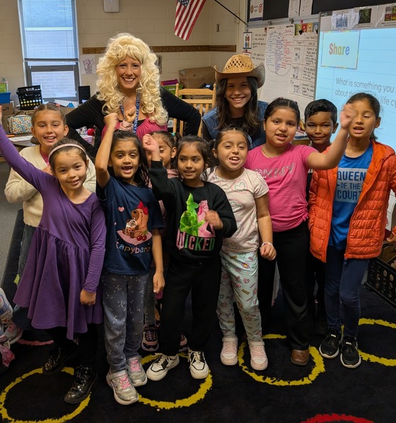 Teacher dressed as Dolly Parton with students