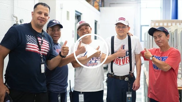 FCPS Custodians smiling with a Youtube play button overlay
