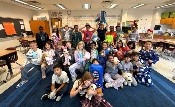 Students wearing pajamas with stuffed animals