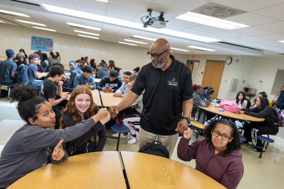 Julian Gaither with students in the cafeteria