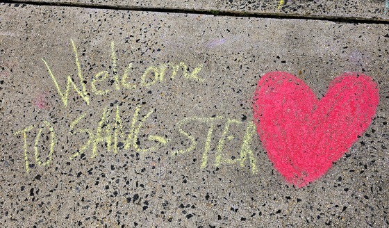 Chalk messages welcome everyone to Sangster during Blue Star Week