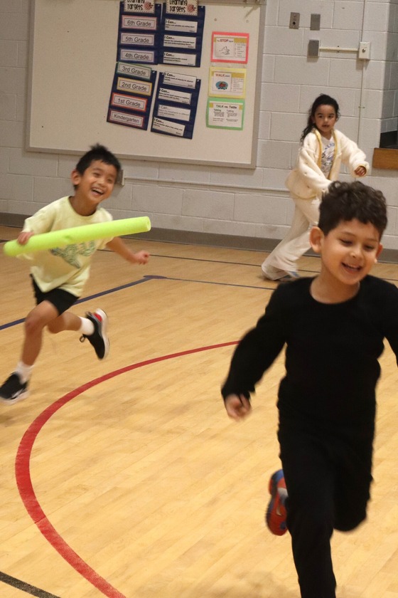 A group of 3 students running during PE