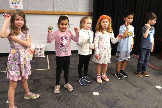 A group of 6 students dancing during music class