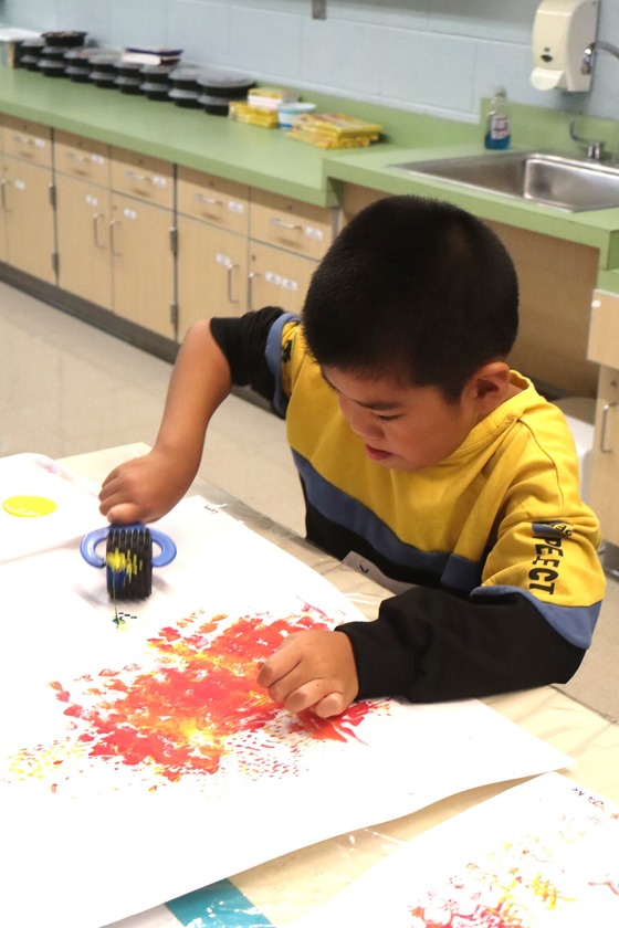 A student painting during specials