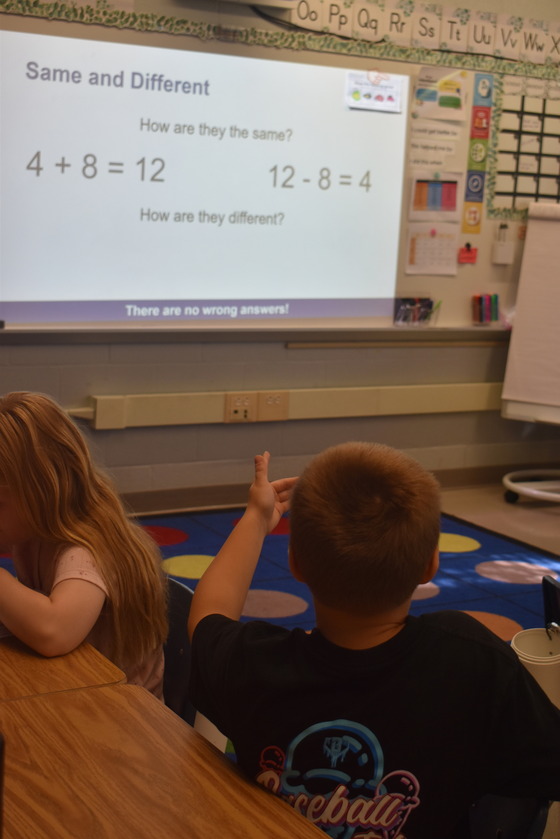 A student at the smart board solving a math problem