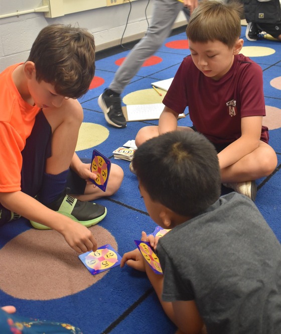 A group of 3 students playing math games