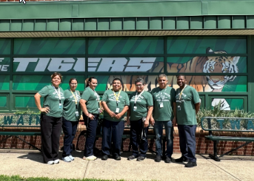 a photo of the Mark Twain Middle School Custodial Team in front of the school.