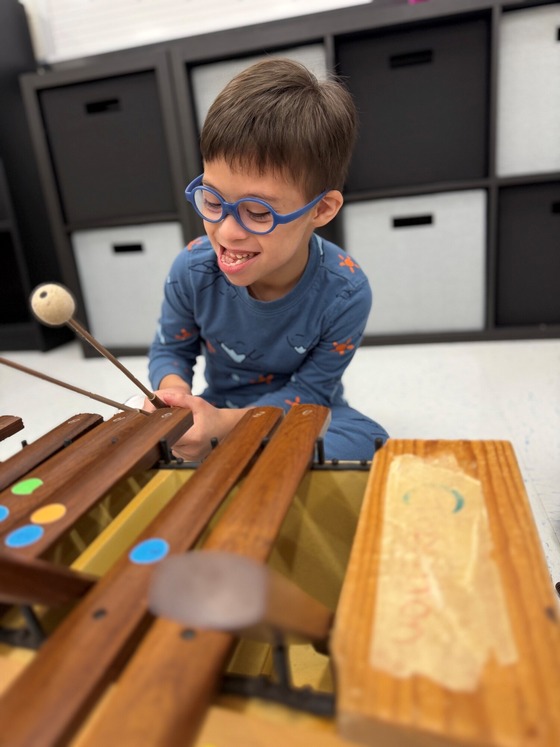 student playing music on a xylophone