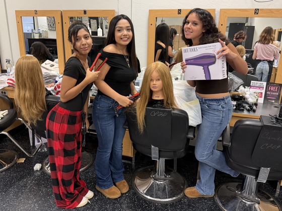 Cosmetology students unboxing their salon kits