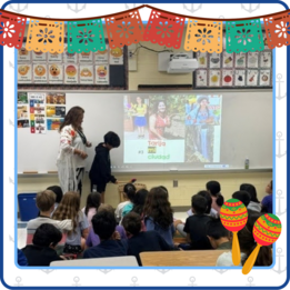 Image of teacher in front of class showing slides for hispanic heritage month