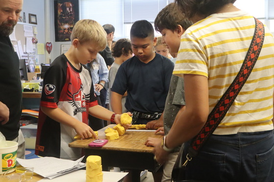 3 boys presenting their work during the 6th grade parent invite