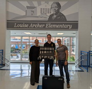Handbell Ensemble Member lending Louise Archer Elementary a set of handbells