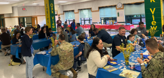 Military families eating a pancake breakfast