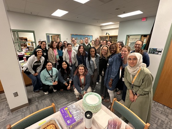 Staff stand in a group and pose for a picture