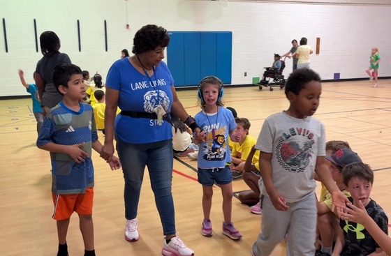 Students with multiple abilities running the Fun Run in the gym
