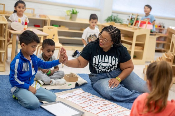 Principal Rashida Green high fives a student