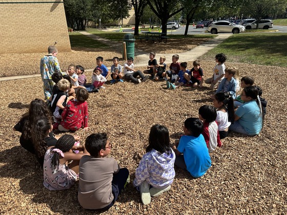 Students playing Duck, Duck, Goose game.