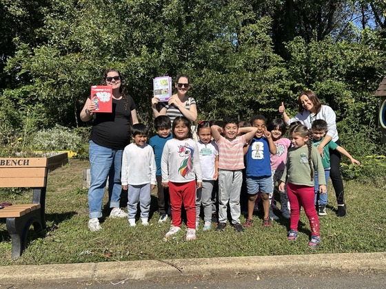 student outside with books making real world connections