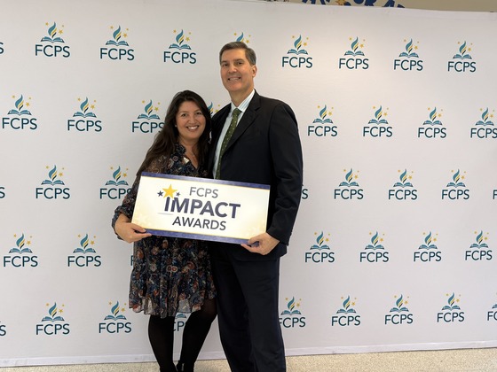 Iva Plazas and her husband accepting her Impact Award