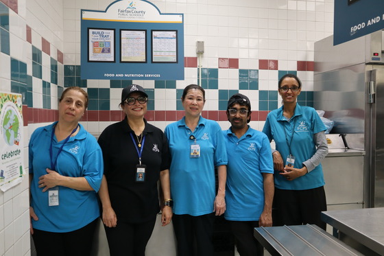 A picture of our Cafeteria staff in the cafeteria line.