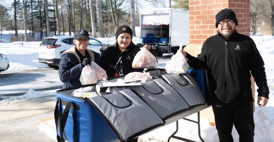 Melissa DeAngelo and staff hand out food during a snow storm