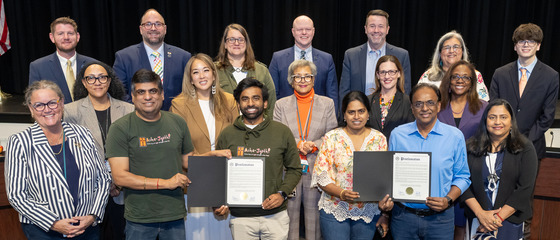 School Board Members and community at the dais celebrating the Proclamation recognizing Asha-Jyothi.