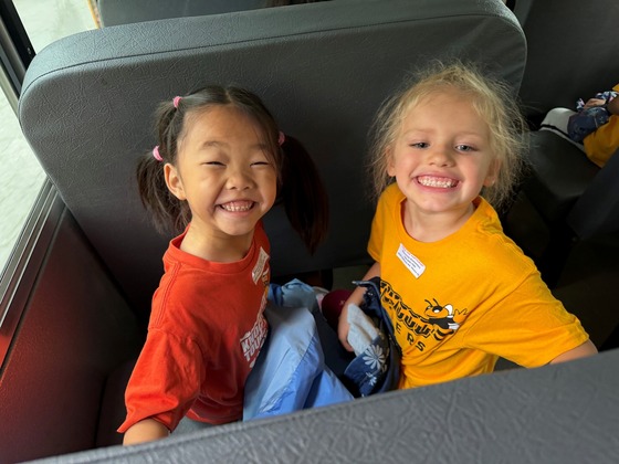 A picture of 2 students on the bus heading to Cox Farm