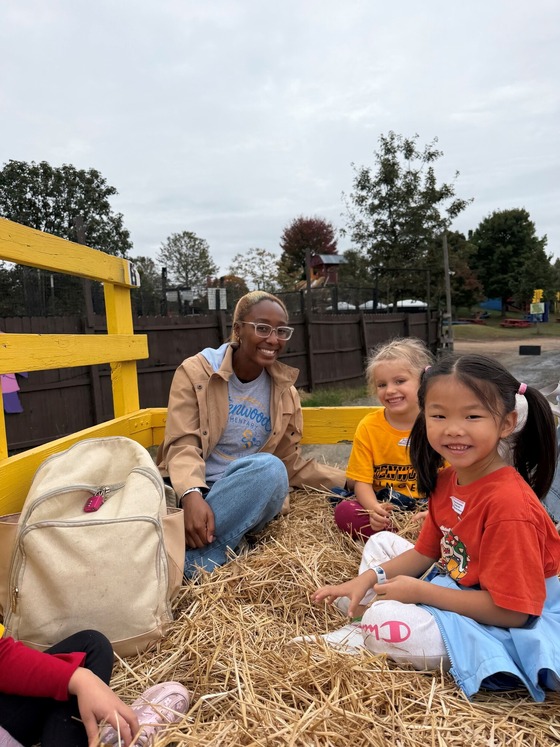 A picture of 3 students on a hay ride at Cox Farm