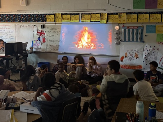 students reading under a virtual campfire