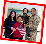 A military family holding a flag