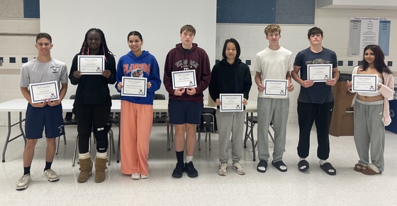 Woodson Cav Kudos Winners. Students holding up certificates for good behaviour