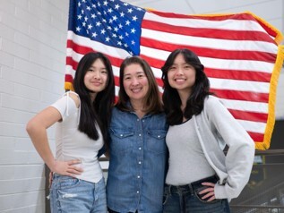 Asian family in front of the American flag