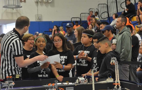 Group of students speaking with a ref at FLL Fun Day