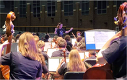 Orchestra camp students rehearsing on stage