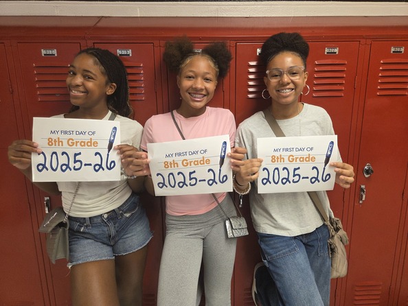 Three students holding up signs that say "My first day of 8th grade 2025-2026"