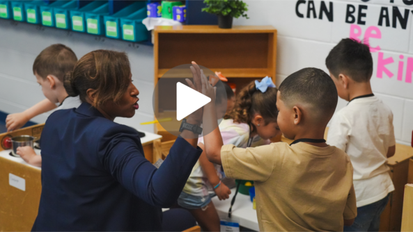 photo screenshot of Dr. McDade giving a student a high five