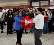 principal and student dancing, students behind them