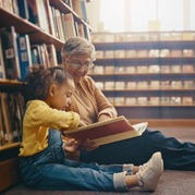 Older woman reading to a child at the library