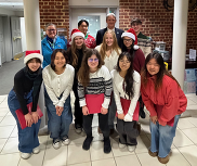 photo of chorus carolers with superintendent dr. wright and dr. reid