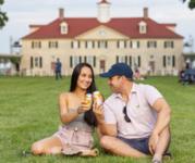 Image of couple sitting in grass at Mount Vernon Summer Fest