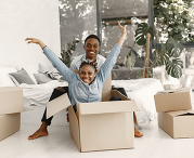 smiling couple with moving boxes