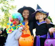 Image of three children dressed in Halloween costumes