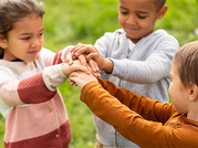 three kids holding hands 