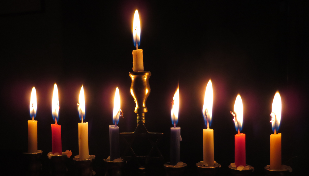 Close up image of nine candles on a menorah