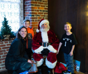 Image of family posing with Santa