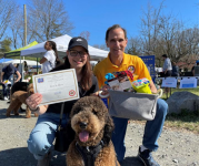 Image of Supervisor Storck with a woman and her dog, holding a certificate 