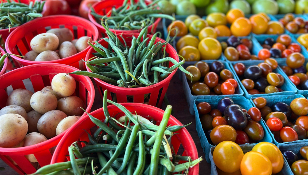 Image of buckets of potatoes, green beans and cherry tomatoes