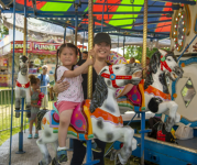 Image of a mother and daughter on a carousel 