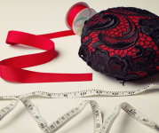 Image of a red and black fascinator hat with red ribbon