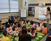 photo of teacher volunteer and students